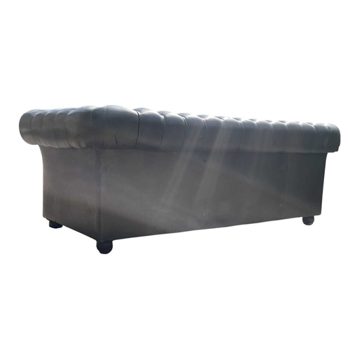 623 - A Chesterfield style 20th century green leather buttoned back three seater sofa. With scrolled elbow... 