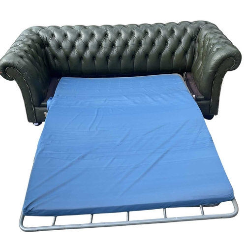 623 - A Chesterfield style 20th century green leather buttoned back three seater sofa. With scrolled elbow... 