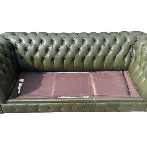 623 - A Chesterfield style 20th century green leather buttoned back three seater sofa. With scrolled elbow... 