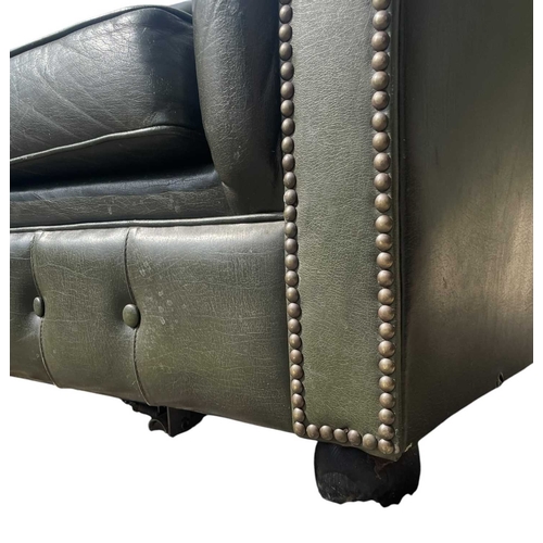 623 - A Chesterfield style 20th century green leather buttoned back three seater sofa. With scrolled elbow... 